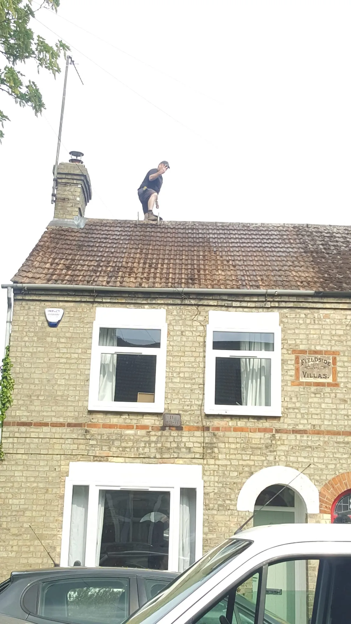 Man on house fixing roof
